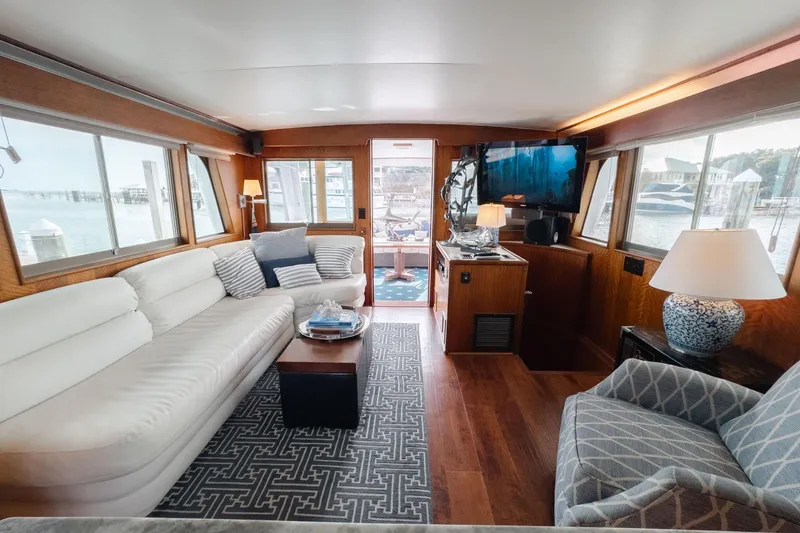Masterplan Yacht Photos Pics Luxurious interior of a 1975 Hatteras 58 Long Range Cruiser with elegant furnishings and large windows.