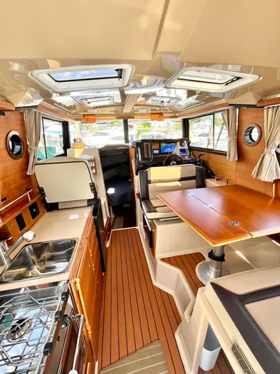  Yacht Photos Pics Interior of 2018 Ranger Tugs R-27 boat with wood finishes and modern amenities.