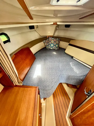  Yacht Photos Pics 2018 Ranger Tugs R-27 cabin interior with cozy bed and wooden accents.