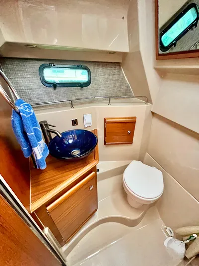  Yacht Photos Pics 2018 Ranger Tugs R-27 boat bathroom with sink, toilet, and window.