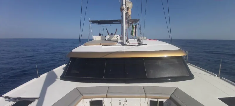 Orange Yacht Photos Pics Front view of 2023 Luna 47 yacht on open sea under clear blue sky.
