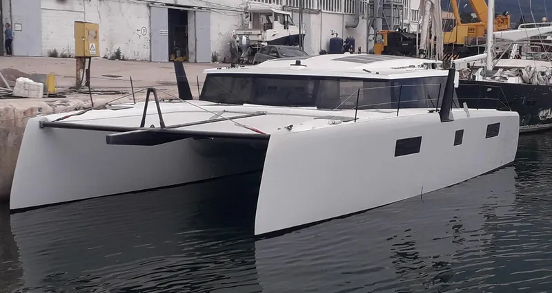 Orange Yacht Photos Pics Modern Luna 47 catamaran docked at a marina, 2023 model.