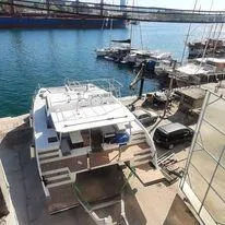 Orange Yacht Photos Pics Modern Luna 47 yacht docked at marina, 2023 model, with scenic waterfront view.