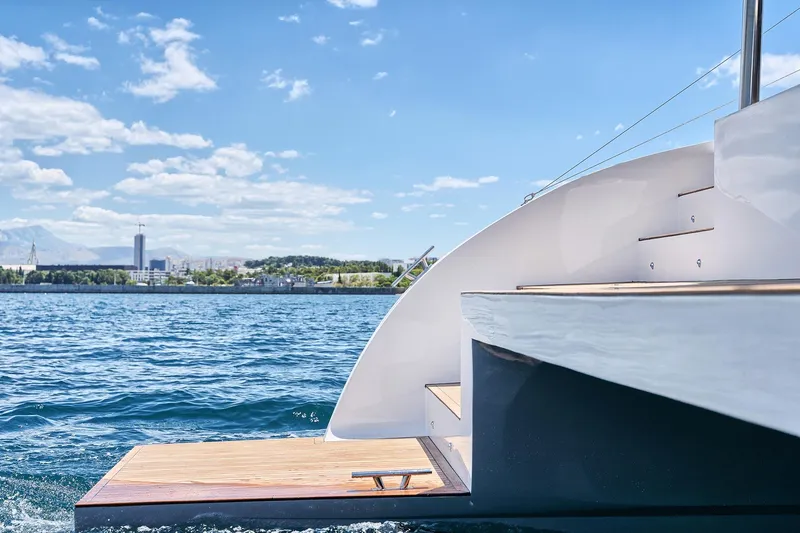 Orange Yacht Photos Pics Modern Luna 47 yacht on blue water with city skyline in background, 2023 model.