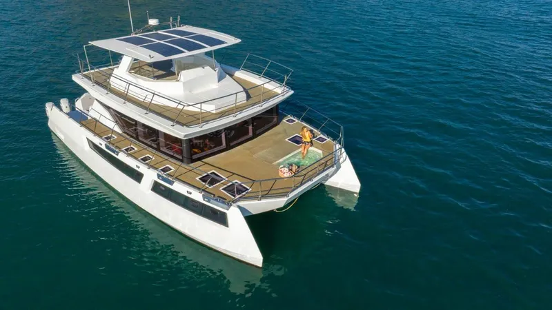Pilar X Yacht Photos Pics 2024 Leeuwin 55 yacht cruising on open water, featuring spacious deck and modern design.