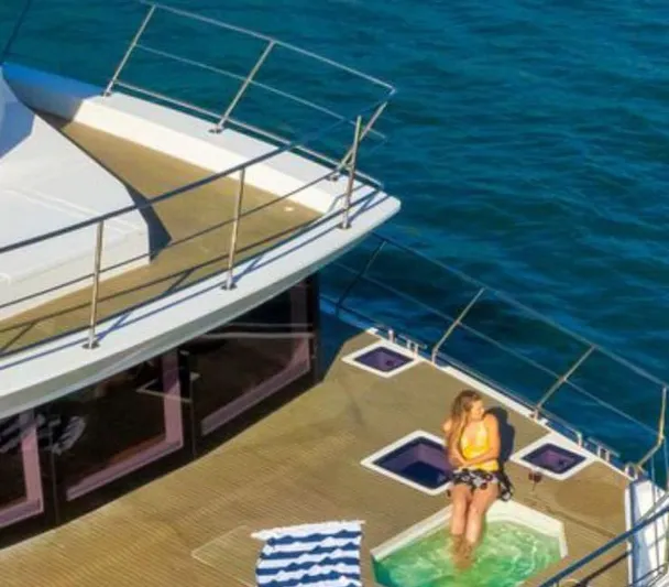 Pilar X Yacht Photos Pics Woman relaxing in jacuzzi on 2024 Leeuwin 55 yacht deck, ocean view.