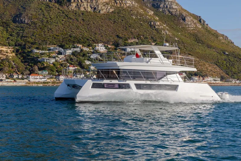 Pilar X Yacht Photos Pics 2024 Leeuwin 55 yacht cruising near scenic coastal landscape.