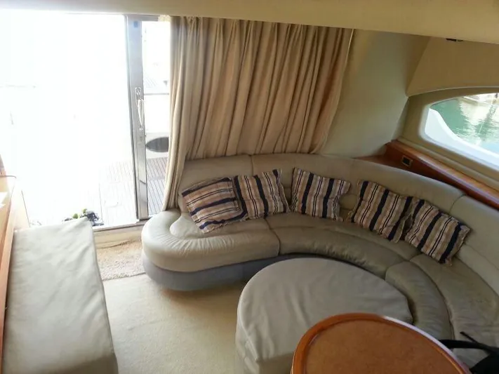  Yacht Photos Pics Luxurious interior of a 2008 Azimut 55 yacht with curved seating and striped cushions.