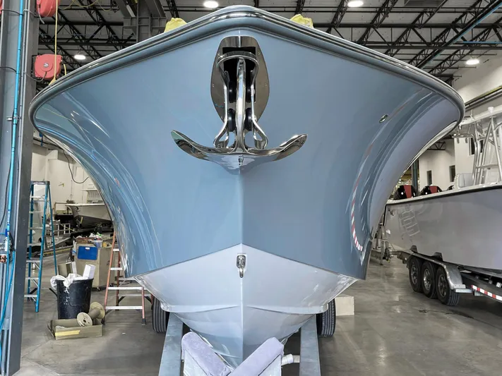  Yacht Photos Pics 2021 SeaVee 370z boat in a warehouse, showcasing its sleek hull design.