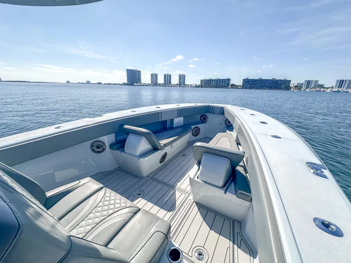  Yacht Photos Pics 2021 SeaVee 370z boat interior with luxurious seating, overlooking a calm waterfront cityscape.