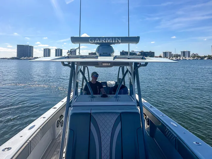  Yacht Photos Pics 2021 SeaVee 370z boat on water, city skyline in background, Garmin equipment visible.