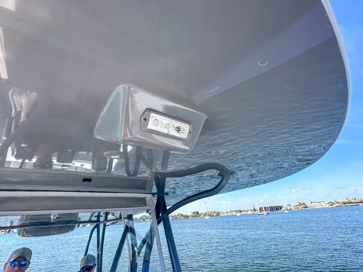  Yacht Photos Pics 2021 SeaVee 370z boat canopy with light, overlooking calm waters.