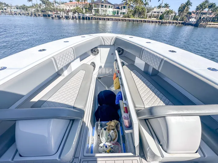  Yacht Photos Pics 2021 SeaVee 370z boat interior with seating and storage, docked by waterfront homes.