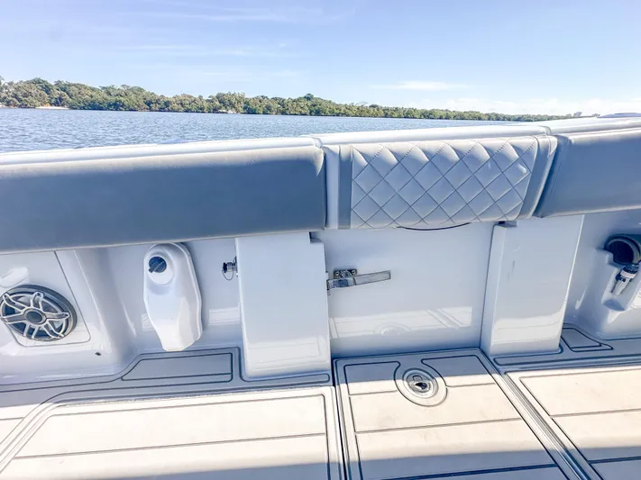  Yacht Photos Pics 2021 SeaVee 370z boat interior with cushioned seating and scenic water view.