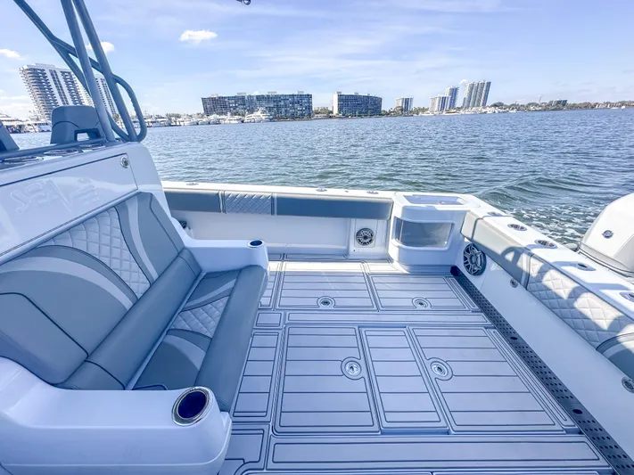  Yacht Photos Pics 2021 SeaVee 370z boat interior with modern seating, overlooking a waterfront cityscape.