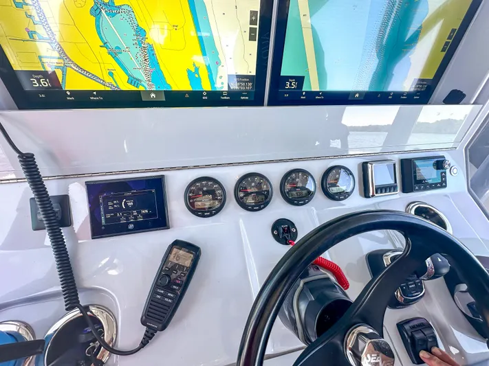  Yacht Photos Pics Control panel of a 2021 SeaVee 370z boat with navigation screens and gauges.