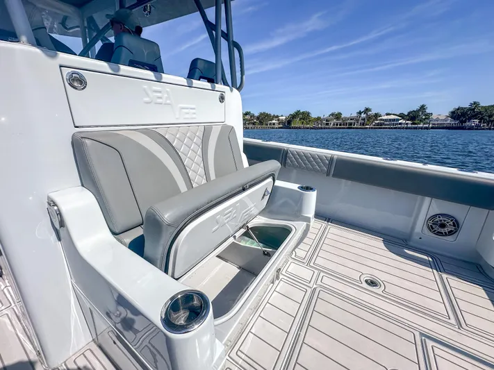  Yacht Photos Pics 2021 SeaVee 370z boat interior with seating and storage, on a sunny day by the water.