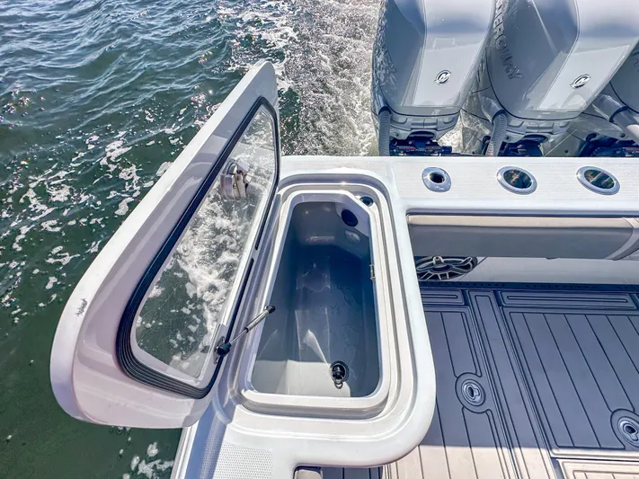  Yacht Photos Pics 2021 SeaVee 370z boat with open storage compartment and triple outboard engines.