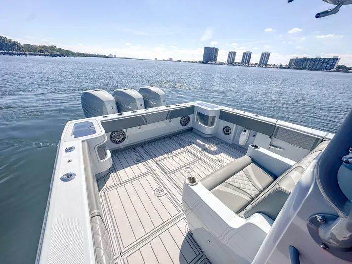  Yacht Photos Pics 2021 SeaVee 370z boat with triple engines on a calm waterway.