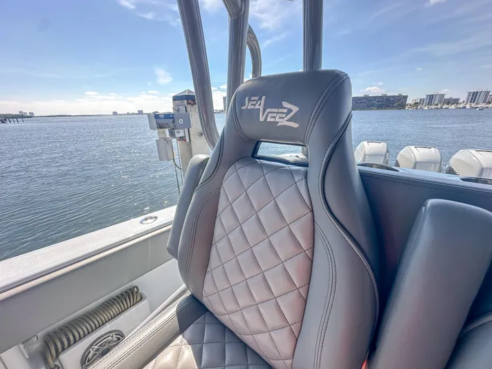  Yacht Photos Pics Luxurious SeaVee 370z 2021 boat seat with quilted design, overlooking serene waterfront.