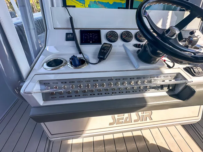  Yacht Photos Pics 2021 SeaVee 370z boat dashboard with controls, steering wheel, and navigation equipment.