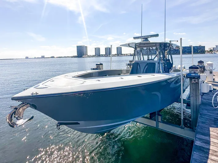  Yacht Photos Pics 2021 SeaVee 370z boat docked, with city skyline in the background on a sunny day.