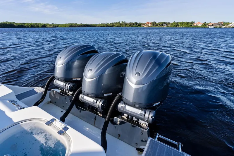 No Name Yacht Photos Pics 2023 Cobia 350 Center Console with triple outboard engines on open water.