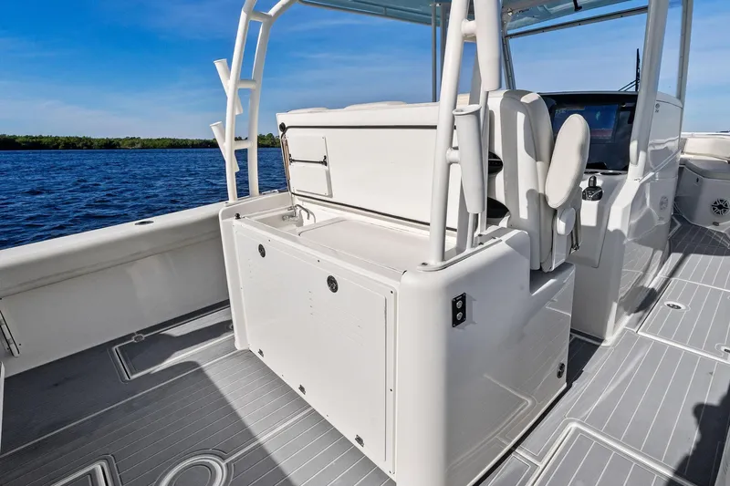 No Name Yacht Photos Pics 2023 Cobia 350 Center Console boat interior with seating and storage, on a sunny day.