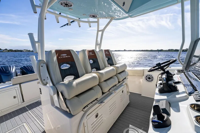 No Name Yacht Photos Pics 2023 Cobia 350 Center Console boat interior with luxurious seating and helm, overlooking serene waters.