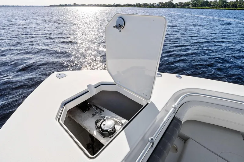 No Name Yacht Photos Pics 2023 Cobia 350 Center Console boat with open storage compartment on calm water.