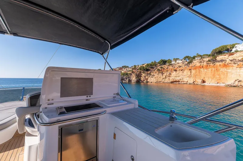  Yacht Photos Pics Luxury Sunseeker Manhattan 70 yacht, 2008 model, with scenic coastal view.