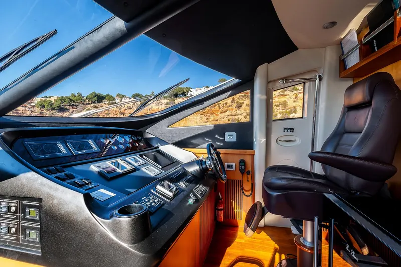  Yacht Photos Pics Luxurious 2008 Sunseeker Manhattan 70 yacht cockpit with modern controls and leather seating.