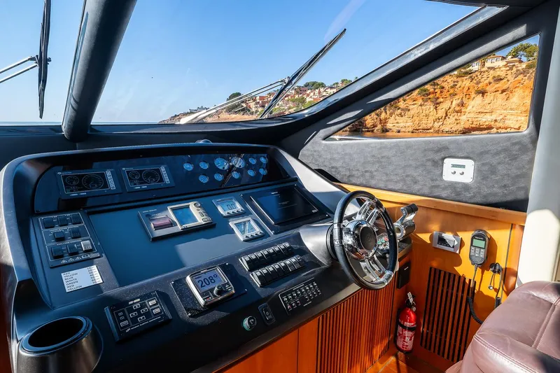  Yacht Photos Pics Cockpit of 2008 Sunseeker Manhattan 70 yacht with modern controls and ocean view.
