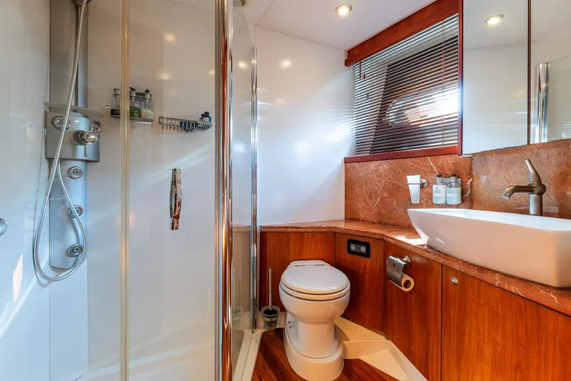  Yacht Photos Pics Luxurious bathroom in 2008 Sunseeker Manhattan 70 yacht with modern fixtures and wood accents.