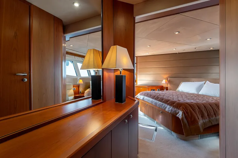  Yacht Photos Pics Luxurious bedroom interior of 2008 Sunseeker Manhattan 70 yacht with elegant wood finishes.