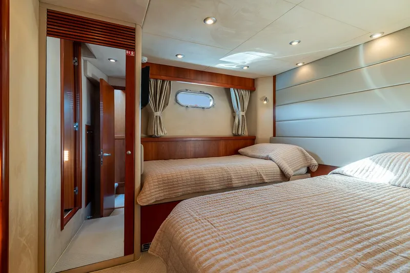  Yacht Photos Pics Luxurious cabin interior of 2008 Sunseeker Manhattan 70 yacht with twin beds and elegant decor.