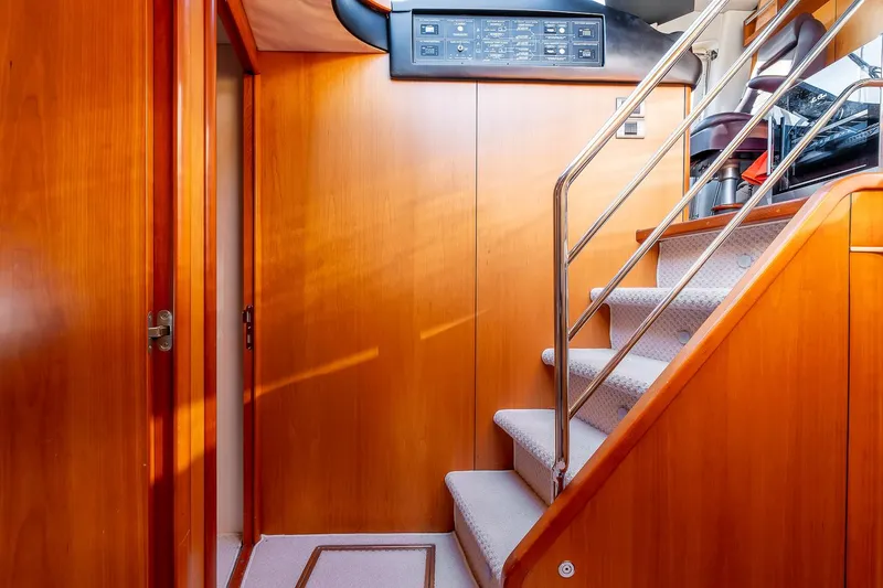  Yacht Photos Pics Staircase interior of 2008 Sunseeker Manhattan 70 yacht with wooden paneling.