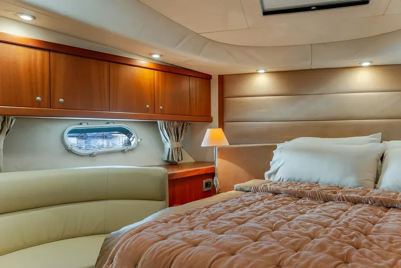  Yacht Photos Pics Luxurious cabin interior of 2008 Sunseeker Manhattan 70 yacht with cozy bed and elegant lighting.