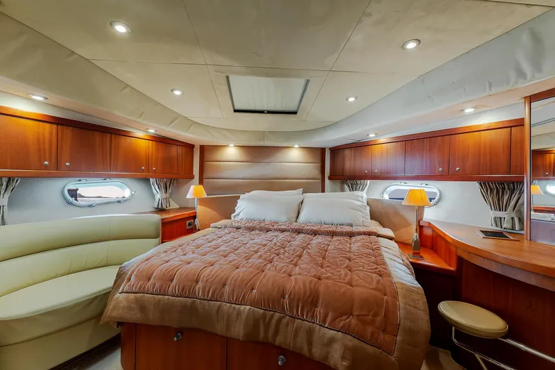  Yacht Photos Pics Luxurious bedroom interior of 2008 Sunseeker Manhattan 70 yacht with elegant wood finishes.