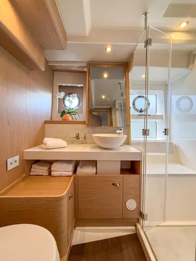 In Stock Yacht Photos Pics Luxurious bathroom in 2026 Beneteau Swift Trawler 54, featuring modern fixtures and elegant wood finishes.