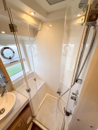 In Stock Yacht Photos Pics Bathroom interior of 2026 Beneteau Swift Trawler 54, featuring modern shower and sink.
