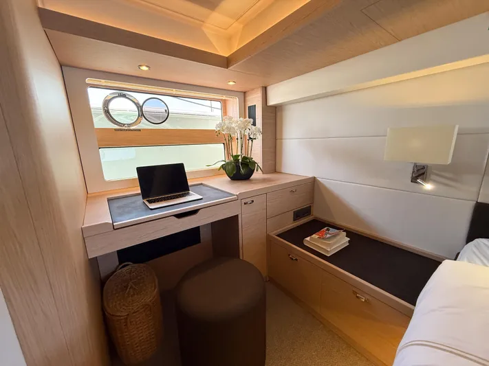 In Stock Yacht Photos Pics Luxurious cabin interior of 2026 Beneteau Swift Trawler 54 with desk and window view.
