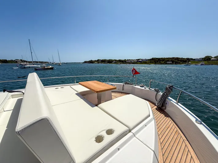 In Stock Yacht Photos Pics Luxurious deck of 2026 Beneteau Swift Trawler 54, overlooking serene waters and sailboats.