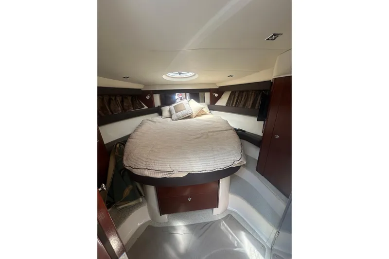 Havadk Yacht Photos Pics Interior of 2010 Meridian 391 Sedan yacht with cozy bed and elegant wood finish.