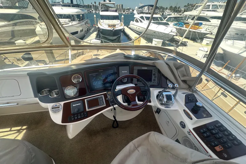 Havadk Yacht Photos Pics 2010 Meridian 391 Sedan helm with navigation controls, docked at marina with yachts.