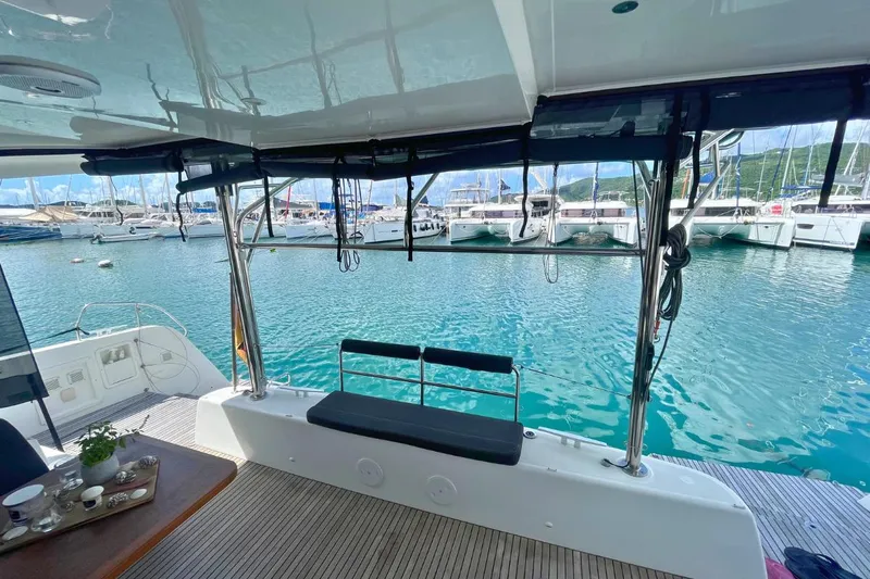 Lucky Vibes Yacht Photos Pics Lagoon 42 catamaran's deck with marina view, featuring seating and table setup, 2018 model.
