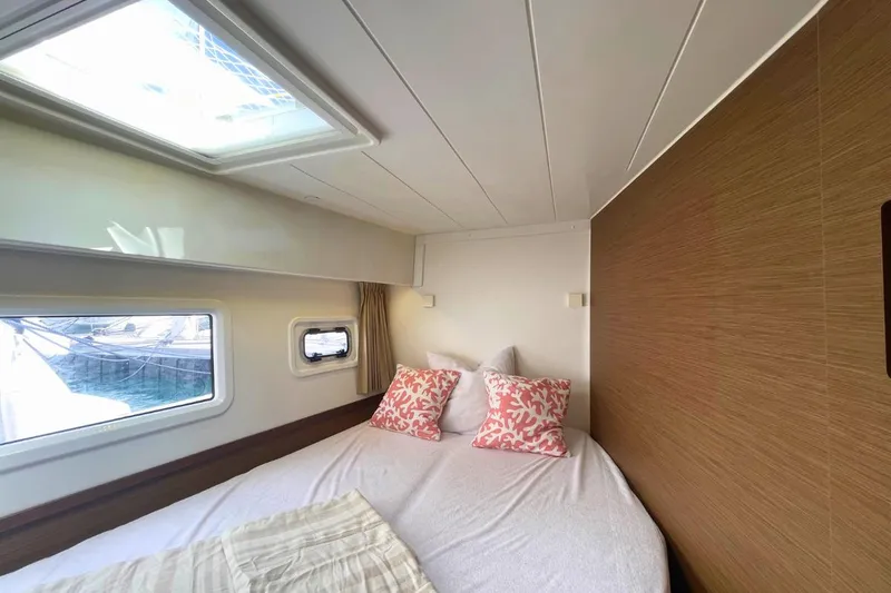 Lucky Vibes Yacht Photos Pics Interior cabin of 2018 Lagoon 42 catamaran with bed and windows.