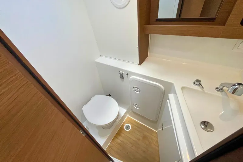 Lucky Vibes Yacht Photos Pics 2018 Lagoon 42 yacht bathroom with modern fixtures and wooden accents.