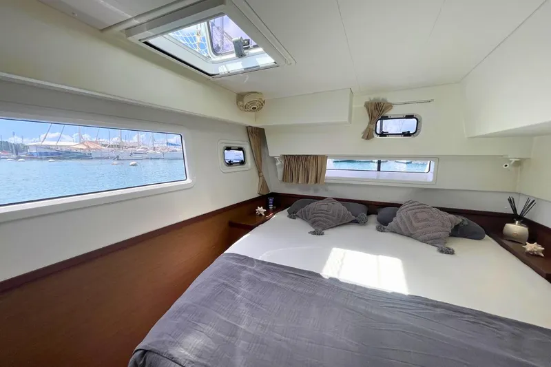 Lucky Vibes Yacht Photos Pics Luxurious cabin interior of 2018 Lagoon 42 catamaran with scenic marina view.