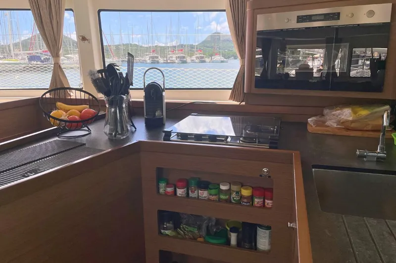 Lucky Vibes Yacht Photos Pics Interior of 2018 Lagoon 42 catamaran kitchen with fruit basket and spices.
